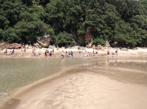 The view of Hot Water Beach from a sandbar.  If you look closely, J is sitting against a rock with a towel over his head napping!